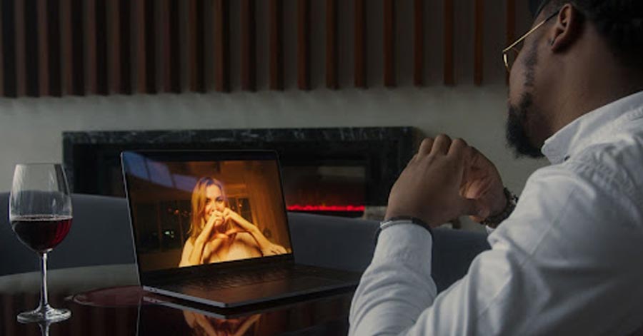 A couple making a heart sign during their virtual date.