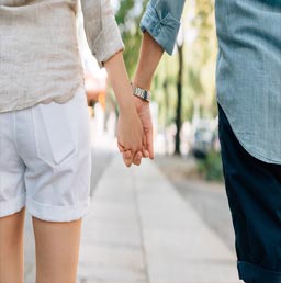 A picture of a couple holding hands