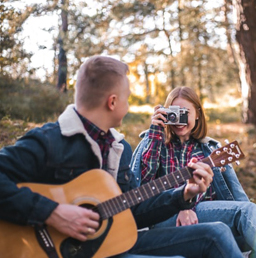 A happy couple enjoying the fresh air out in the woods.